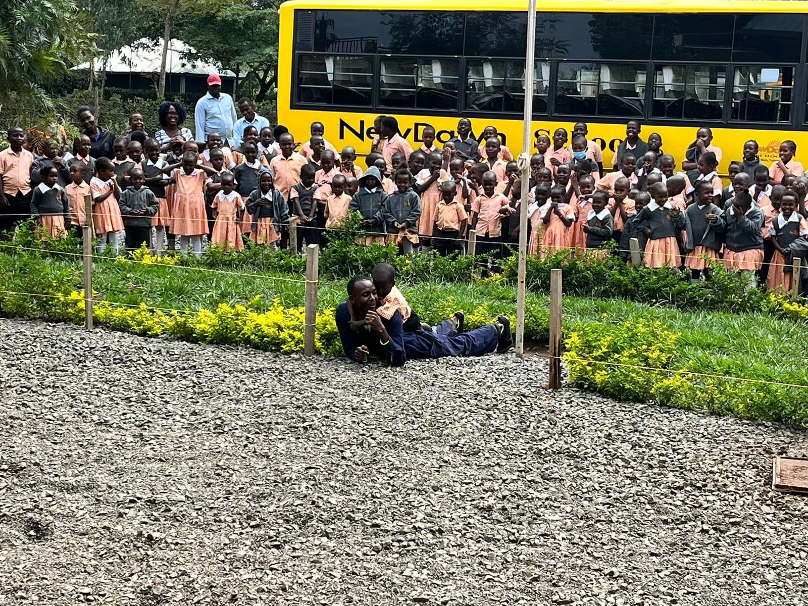 NewDawn learners and staff gathered beside a school bus
