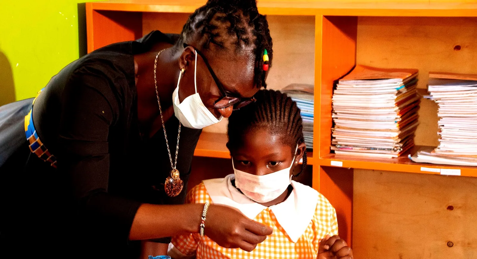 A teacher supporting a learner in class