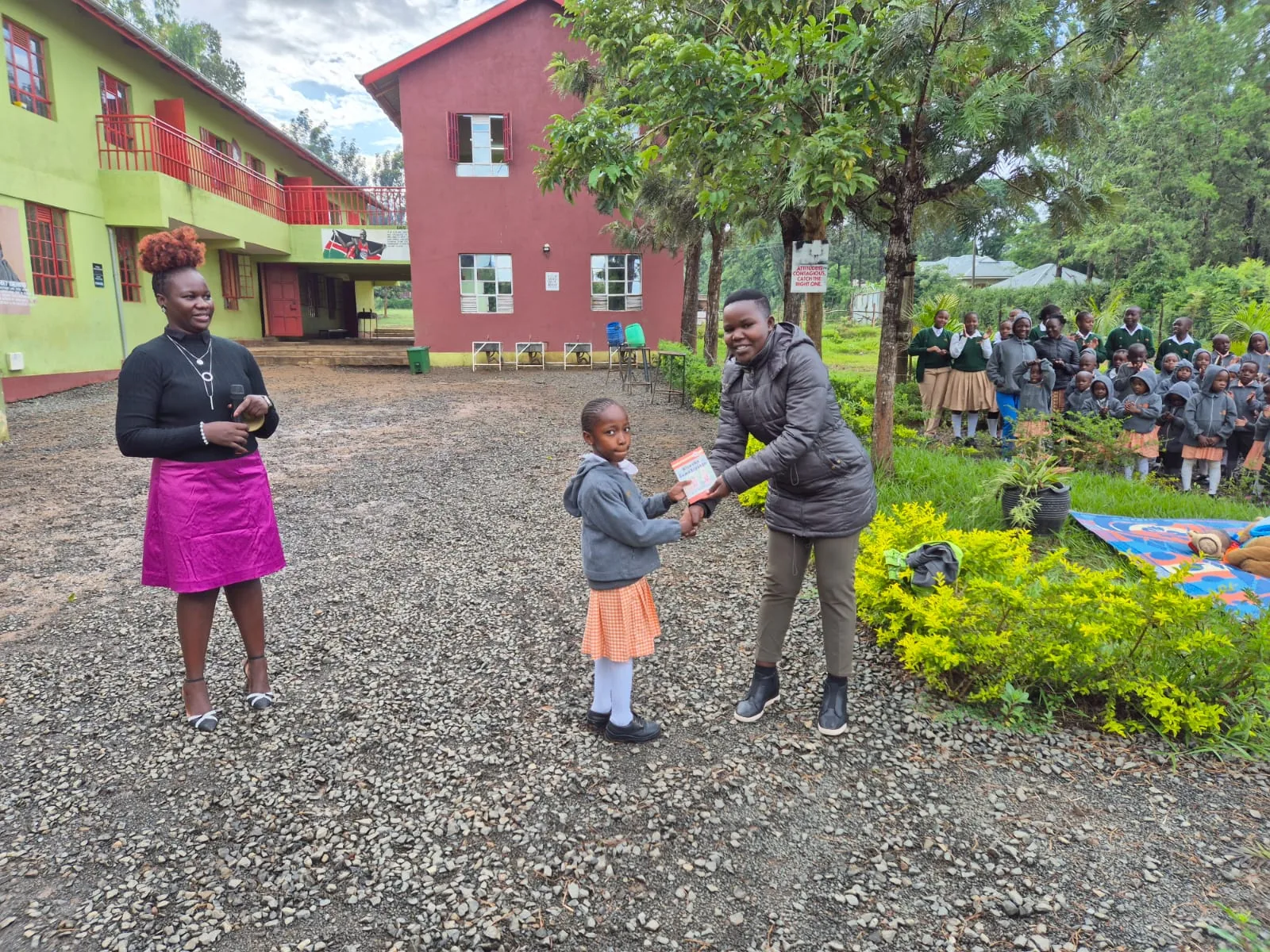 A teacher and learners in the NewDawn school grounds